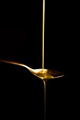goldy liquid in a goldy spoon