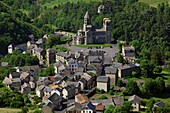 France, Puy de Dome (63), Clermont-Ferrand, mountain village, dominated by its famous twelfth-century Romanesque church, historic monument, Common Regional Natural Park of Auvergne Volcanoes (aerial view)