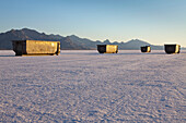 Large garbage  and recycling containers on Bonneville Salt Flats in  Speed Week, an annual amateur auto racing event. A row of four large containers for trash. Utah, USA., Bonneville Salt Flats in Speed Week