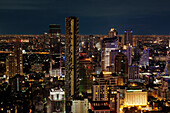 A view over the city at night. Buildings lit up, skyscrapers illuminated against the evening sky. Modern downtown area. Tall buildings., Bangkok, Thailand at night