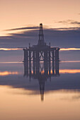 Oil rig anchored in the Cromarty Firth at sunset, Cromarty Firth, Ross-shire, Scotland, UK., Oil rig anchored in the Cromarty Firth, Scotland.