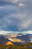 Storm and weather patterns. Approaching rain showers, clouds and rain falling. Viewed across the valleys and peaks of Tombstone Territorial Park. The Ogilvie Mountains, in the Tombstone range., Tombstone Territorial Park Yukon Canada