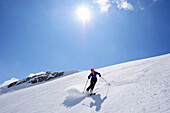 Woman backcountry skiing, descending on snow face, Schesaplana, Raetikon, Montafon, Vorarlberg, Austria