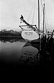 Sailor Adjusting Rigging on Sailboat