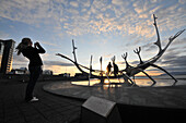 Sun voyager monument on the waterfront at dusk, Saebraut, Reykjavik, Iceland, Europe