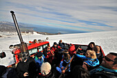 Tourists in a snowmobile going to the Snaefellsjoekull, Snaefellsnes peninsula, West Iceland, Europe