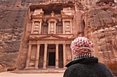 Jordan, Petra-Wadi Musa, Ancient Nabatean City of Petra, The Treasury, Al-Khazneh and man in keffiyeh headscarf, NR