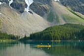 Canoeists paddling on Moraine Lake, Banff National Park Alberta Canada