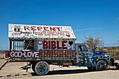 Niland, California - Salvation Mountain, a desert hillside covered with religious messages, created by Leonard Knight  An old truck decorated with religious slogans is on the property