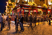 People outside The Temple Bar in Temple Bar district at night, Dublin, County Dublin, Ireland