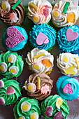 Broken heart on colorful cupcake display in bakery, Porthmadog, Gwynedd, Wales, United Kingdom