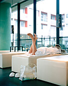 Woman on a lounger in relaxation room of a spa, Langenlois, Lower Austria, Austria