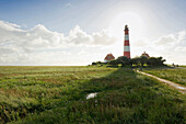 Backlit Westerheversand lighthouse, Westerhever, Wadden Sea National Park, Eiderstedt peninsula, North Frisian Islands, Schleswig-Holstein, Germany, Europe