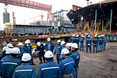 Shipyard workers doing morning exercises before shift, modular production at largest shipyard in the world Hyundai Heavy Industries, HHI, in Ulsan, South Korea, Asia