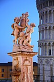 Cherubs holding shield bearing with the leaning tower behind, Pisa, Italy
