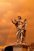 Dark storm clouds and a rainbow over an angel the Bridge of Angels, Rome, Italy, Europe