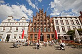street cafe and typical buildings on the central market square of the Hanseatic City of Greifswald, Mecklenburg-Vorpommern, Germany