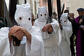 Hooded men in procession on Good Friday, Troia, Apulia, Italy