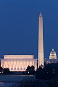 The Lincoln Memorial, Washington Monument, and US Capitol building in the twilight hour after sunset as seen from Arlington, Virginia, USA