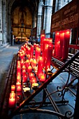 Red praying candles at the Holy Cross and Saint Eulalia Cathedral of Barcelona, Spain