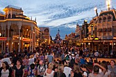 People in the Main Street USA at night waiting for the parade at Disneyland Paris in France