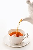 Pouring Tea into White China Cup