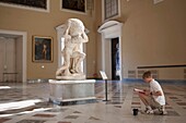 Italy - Campania - Naples - archaeological Museum - child drawing the statue of the Atlas Farnèse carrying(wearing) the celestial globe in the big loung of Atlas