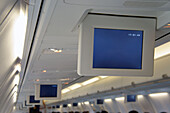 Drop down screens on an aircraft. Television and information monitors for passengers. Inflight entertainment.