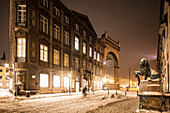 Feldherrnhalle, Odeonsplatz and lion statue, bicyclist at night in snow drift, Munich, Upper Bavaria, Bavaria, Germany