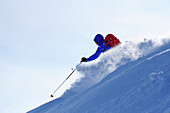 Young man downhill skiing from mount Sulzspitze, Tannheim Mountains, Allgaeu Alps, Tyrol, Austria