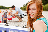 Young woman on Isar riverbank, Munich, Bavaria, Germany
