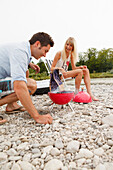 Young couple on the Isar riverbank, Munich, Bavaria, Germany