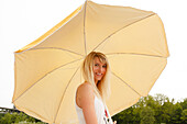 Young woman with a sunshade, Munich, Bavaria, Germany