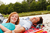 Young couple on bank of Isar river, Munich, Bavaria, Germany