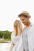 Young couple on the Isar riverbank, Munich, Bavaria, Germany
