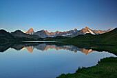 Mont Blanc range with Grandes Jorasses and Mont Dolent reflecting in a mountain lake, Pennine Alps, Aosta valley, Italy