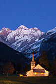 Dusk at the catholic church of Kandersteg and Bluemlisalpmassiv, Bernese Oberland, Canton of Bern, Switzerland