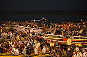 Crowds in boats admire evening Aarti prayer ceremony at Dasaswamedh Ghat alongside Ganges river, Varanasi, Uttar Pradesh, India
