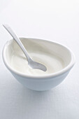 Spoon in bowl of cream. ThickenedCream