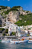 Boats in the harbour and a view of the town of Amalfi on the Gulf of Salerno in southern Italy