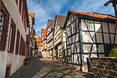 Small alley with traditional houses in Alsfeld on the German Fairy Tale Route, Hesse, Germany, Europe