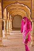 Colorful Hindu woman at Amber Fort temple in Rajasthan Jaipur India