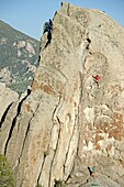 Elijah Weber rock climbing Swiss Cheese which is rated 5,7 and located on the Anteater at The City Of Rocks National Reserve near the town of Almo in southern Idaho