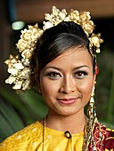 A portrait of Traditional Malaysian dancer wearing a headpiece and stage Make-Up.