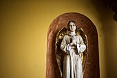 An angel with golden wings praying is displayed in Casa de los Frailes hotel in Oaxaca, Mexico