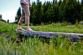 Young Man Crossing Log Barefoot