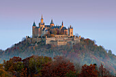 View to Hohenzollern castle in morning mist, near Hechingen, Swabian Alb, Baden-Wuerttemberg, Germany