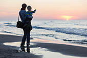 Mother and son watching sunset over Baltic Sea, Bakenberg, Wittow Peninsula, Island of Ruegen, Mecklenburg-Western Pomerania, Germany