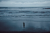 Person Stretching on Beach