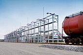 A shale oil storage facility, with storage tanks and railway wagons to transport the product of the oil extraction from rock